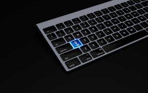 a black keyboard with a blue button on it