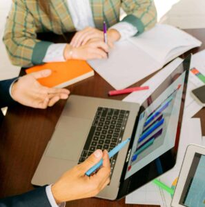 Free A Person in Black Suit Holding a Pen Stock Photo